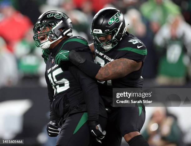 Quinnen Williams of the New York Jets is congratulated by John Franklin-Myers after sacking quarterback Trevor Lawrence of the Jacksonville Jaguars...