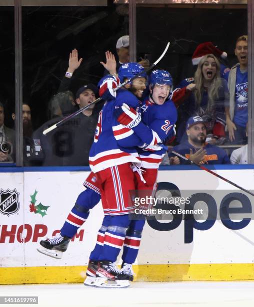 Kaapo Kakko of the New York Rangers celebrates his game winning goal against the New York Islanders and is joined by K'Andre Miller at Madison Square...