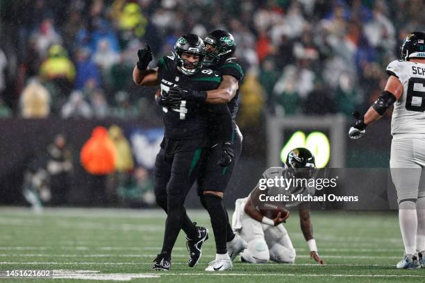 Solomon Thomas of the New York Jets celebrates with a teammate after making a tackle during an NFL football game between the New York Jets and the...