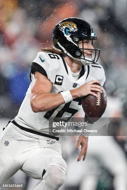 Trevor Lawrence of the Jacksonville Jaguars scrambles and runs with the ball during an NFL football game between the New York Jets and the...