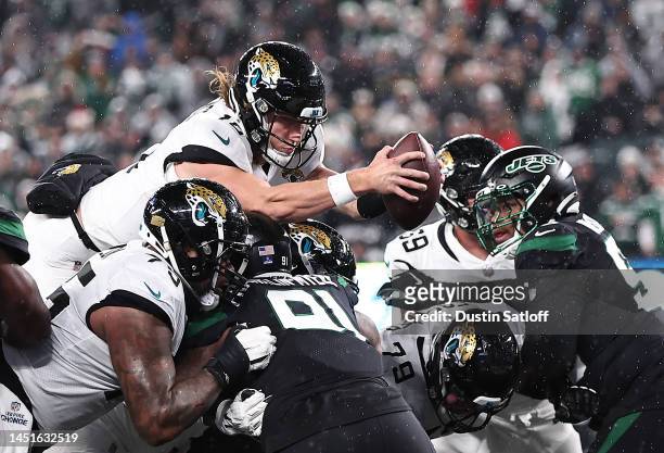 Trevor Lawrence of the Jacksonville Jaguars dives over the goal line for a touchdown during the 1st half of the game against the New York Jets at...