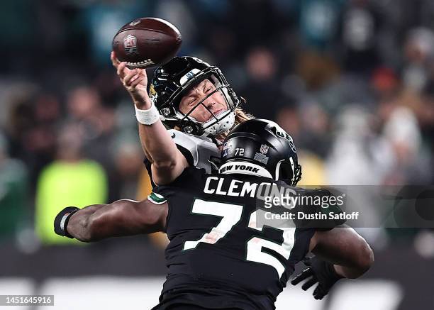 Trevor Lawrence of the Jacksonville Jaguars throws an incomplete pass as he is hit by of the New York Jets during the 4th quarter of the game at...