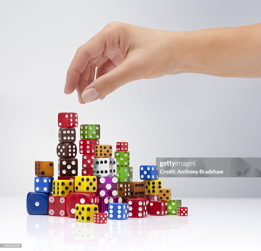 Hand selects a dice
