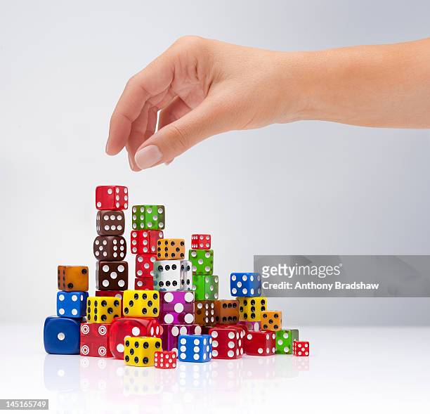 hand selects a dice - choosing stock pictures, royalty-free photos & images