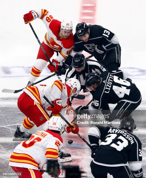 Mikael Backlund of the Calgary Flames and Blake Lizotte of the Los Angeles Kings on a face-off in the third period at Crypto.com Arena on December...