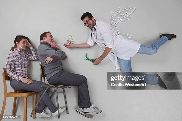 doctor giving medicine to sick patient - man angel wings stock pictures, royalty-free photos & images