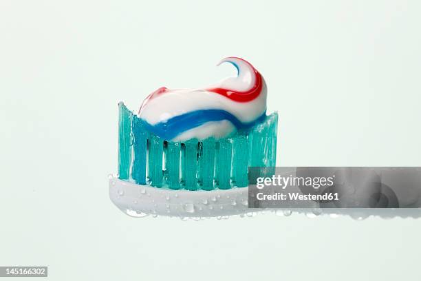 electric toothbrush with toothpaste against white background, close up - toothbrush stock pictures, royalty-free photos & images