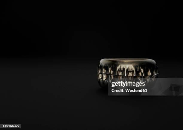 bottle caps on black background - bottle cap stock pictures, royalty-free photos & images
