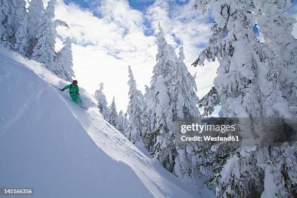 austria, tirol, kitzbuehel, man doing telemark skiing - kitzbuhel stock pictures, royalty-free photos & images