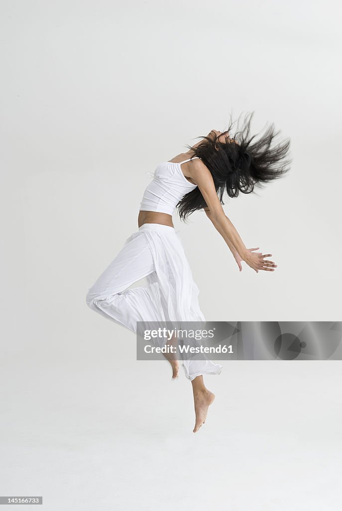 Young woman jumping and dancing