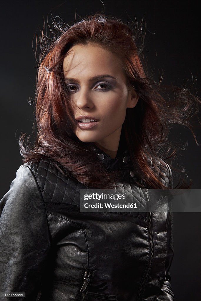 Young woman in black dress and leather jacket, portrait