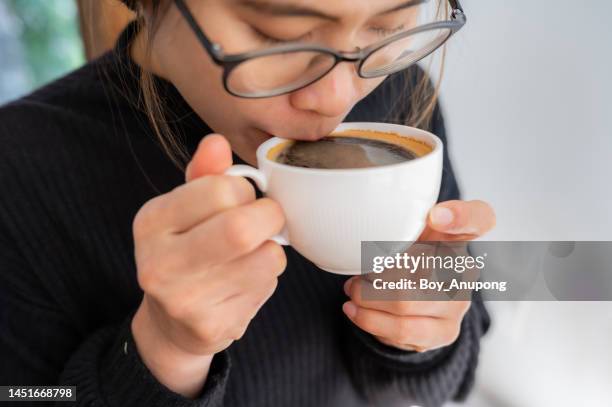 asian woman while drinking black coffee. - black coffee stock pictures, royalty-free photos & images
