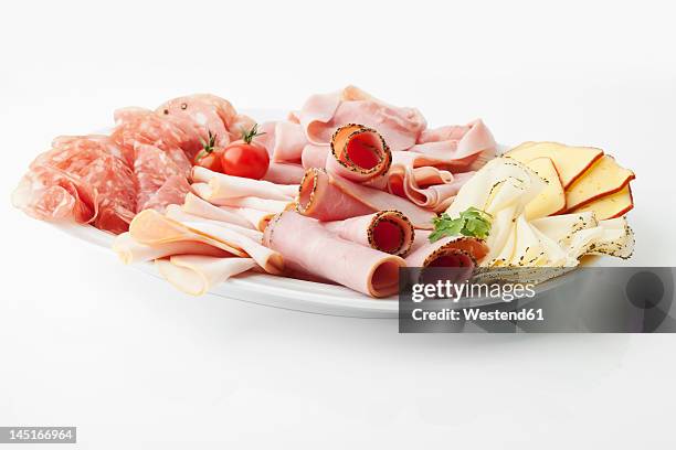 variety of meat and cheese slices in plate on white background - sliced ham stock pictures, royalty-free photos & images