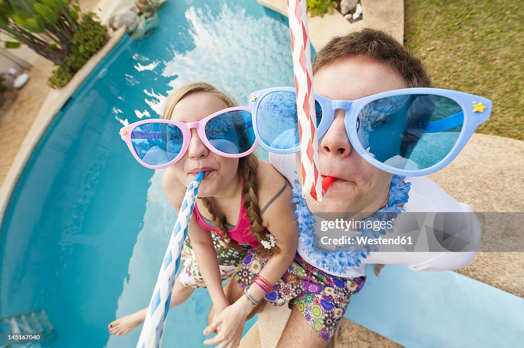 Spain, Mallorca, Couple playing on swimming pool