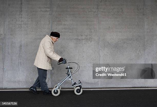 austria, senior woman with wheeled walker at subway - walking frame stock pictures, royalty-free photos & images