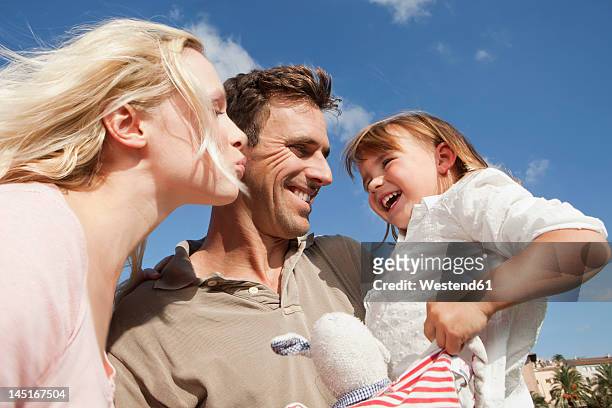 spain, mallorca, palma, family standing together, smiling - 2 year old blonde girl father stock pictures, royalty-free photos & images