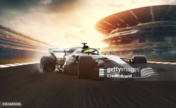 silver race car leading on a race track - car racing stadium stock pictures, royalty-free photos & images