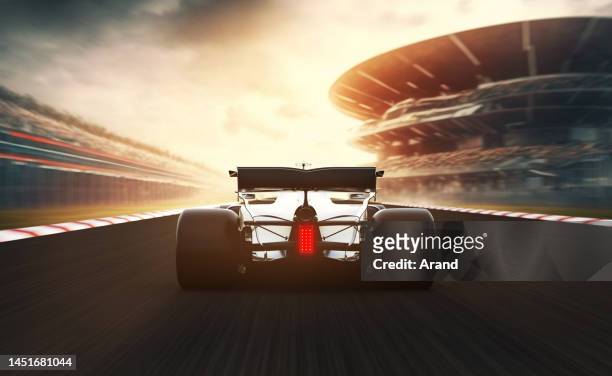 silver race car leading on a race track - car racing stadium stock pictures, royalty-free photos & images