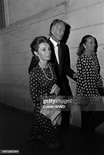 Candids of Fashion Designer Hubert de Givenchy Leaving L'Orangerie Restaurant with Actress Audrey Hepburn and Model Capucine, in Paris.