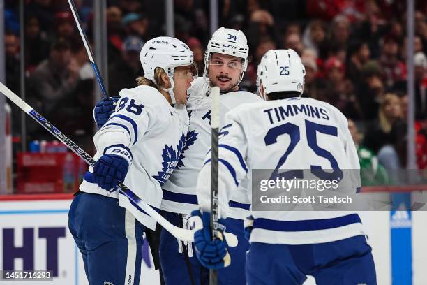 William Nylander of the Toronto Maple Leafs celebrates with Auston Matthews and Conor Timmins after scoring a goal against the Washington Capitals...