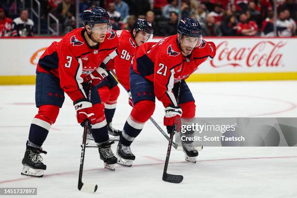 Nick Jensen, Garnet Hathaway, and Nicolas Aube-Kubel of the Washington Capitals line up for a face-off against the Toronto Maple Leafs during the...