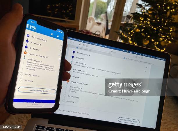 Photo illustration of a person checking the EVRI delivery app on the status of a next day delivery parcel which has not been delivered, stating that...