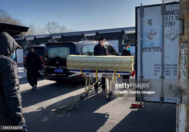 Coffin is loaded into a storage container at the Dongjiao crematorium and funeral home, one of several in the city that handles COVID-19 cases, on...