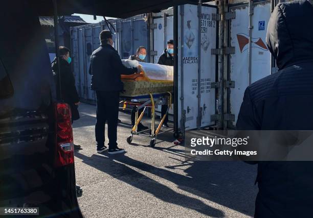 Coffin is loaded into a storage container at the Dongjiao crematorium and funeral home, one of several in the city that handles COVID-19 cases, on...