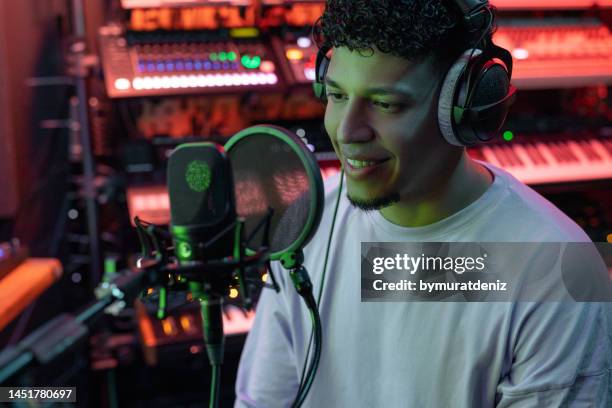 man recording a podcast in a studio - radio dj stock pictures, royalty-free photos & images