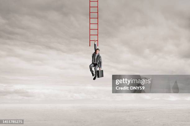 man hanging from bottom rung of ladder - guy looking down stock pictures, royalty-free photos & images