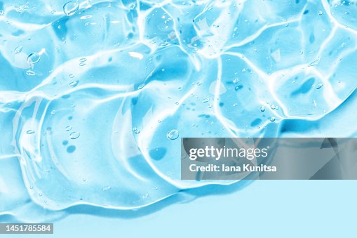 Transparent blue moisture serum for face smudged. Hyaluronic acid. Gel texture with bubbles. Cosmetic products for makeup and skin care. Cosmetology. Transparent blue moisture serum for face smudged. Hyaluronic acid. Gel texture with bubbles. Cosmetic products for makeup and skin care. Cosmetology.
