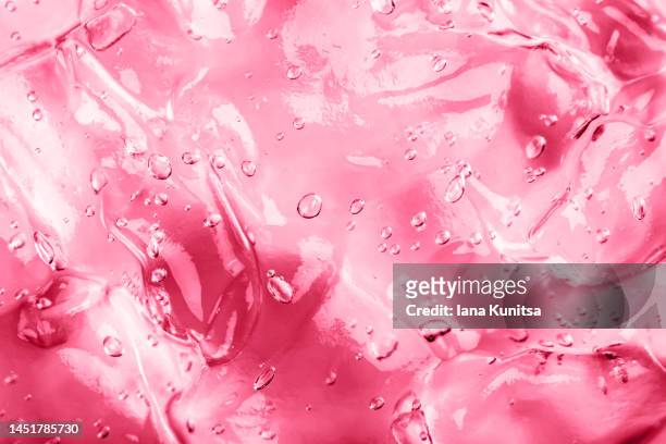 viva magenta gel with bubbles. transparent pink moisture serum for face smudged. cosmetic products for makeup and skin care. color of the year 2023. - lip gloss smudge stock-fotos und bilder