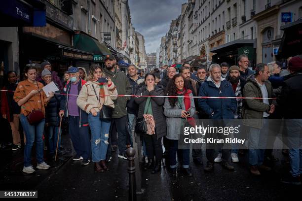 The local community watch and react at the scene of a fatal shooting in the multi-cultural neighbourhood of Strasbourg-Saint Denis in Paris which...