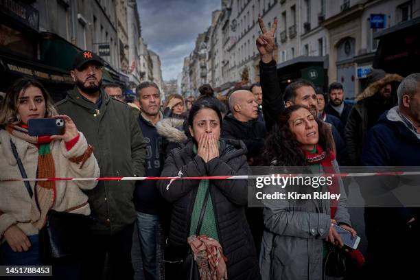 The local community watch in shock at the scene of a fatal shooting in the multi-cultural neighbourhood of Strasbourg-Saint Denis in Paris which left...