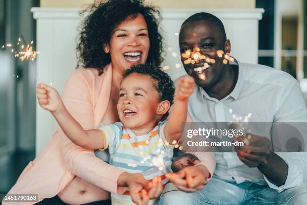 happy family celebrating their anniversary at home - sparkler stock pictures, royalty-free photos & images