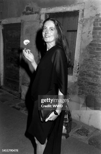 Marie Brandolini AKA Countess Marie Brandolini d'Adda di Valmareno holds flower given by attendants during dinner party after "Made in Milan" film...