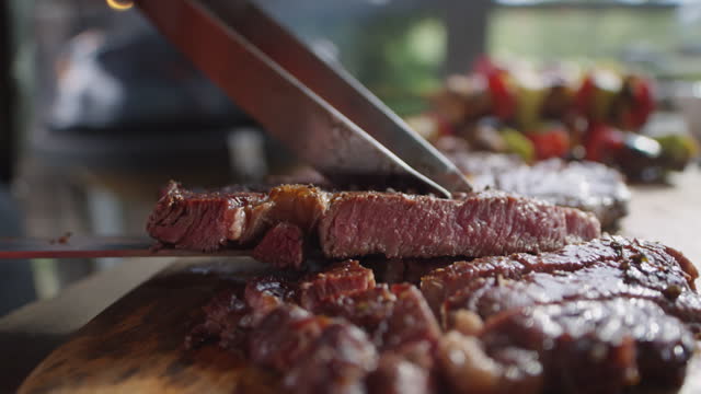 Cutting Beef Steak Grilled on BBQ