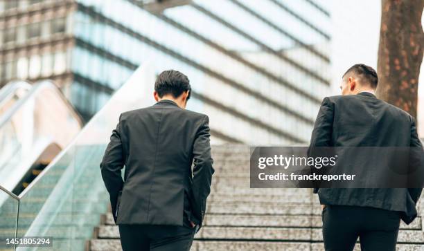 business man commuter walking to work - suspicion employee stock pictures, royalty-free photos & images