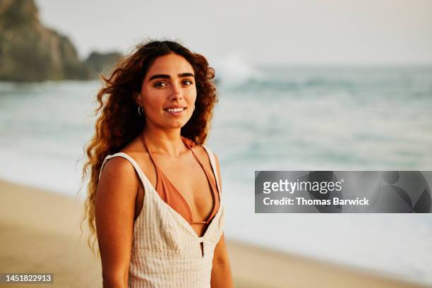 medium shot portrait of woman on tropical beach at sunset - vestido marrón fotografías e imágenes de stock