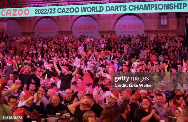 Fans enjoy the action during his Second Round Match against during Day Nine of The Cazoo World Darts Championship at Alexandra Palace on December 23,...