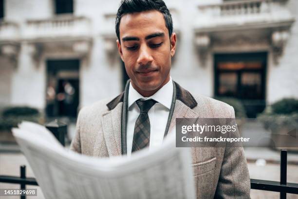 business man reading a newspaper on the street - newspaper luxury bildbanksfoton och bilder