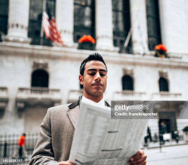 business man reading a newspaper on the street - man in car reading newspaper stock pictures, royalty-free photos & images