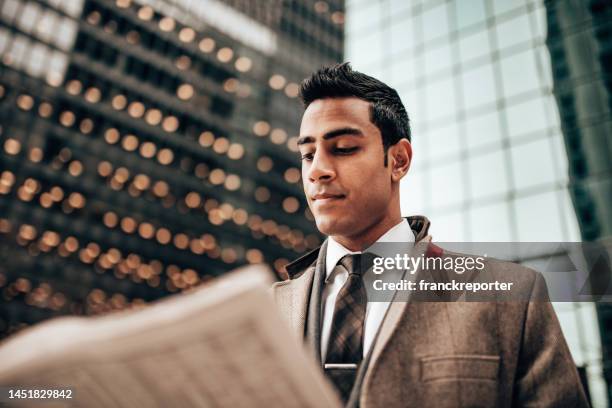 business man reading a newspaper on the street - man in car reading newspaper stock pictures, royalty-free photos & images