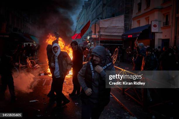 Angry protestors face off towards French Riot Police after violent clashes broke out after the visit of the French Interior Minister Gerald Darmanin...