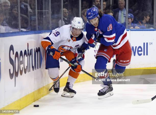 Brock Nelson of the New York Islanders slows down Artemi Panarin of the New York Rangers at Madison Square Garden on December 22, 2022 in New York...
