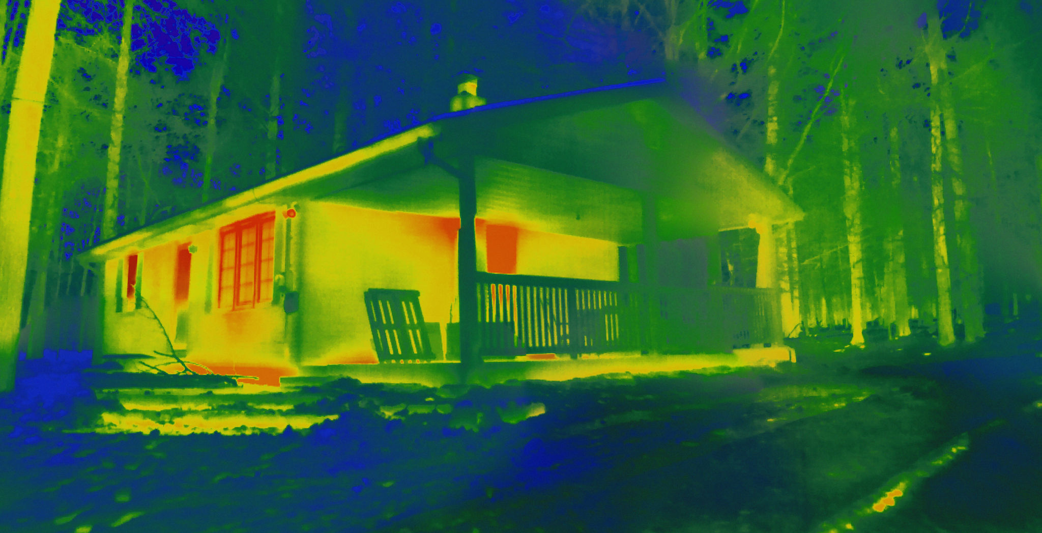 Exterior of a house taken with a heat-sensing camera shows higher amounts of heat emitted in the brighter red and yellow spots. Exterior of a house taken with a heat-sensing camera shows higher amounts of heat emitted in the brighter red and yellow spots.