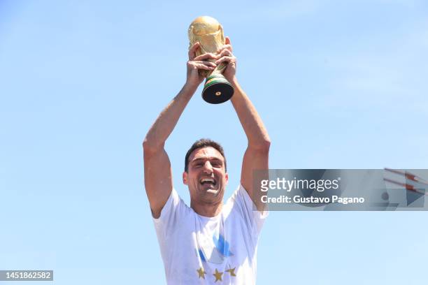 Lionel Scaloni head coach of Argentina celebrates with the FIFA World Cup Qatar 2022 Winner's Trophy during a victory parade of the Argentina men's...