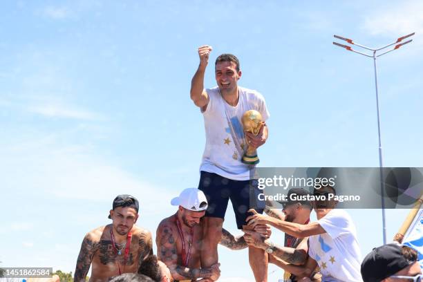 Lionel Scaloni head coach of Argentina celebrates with the FIFA World Cup Qatar 2022 Winner's Trophy during a victory parade of the Argentina men's...