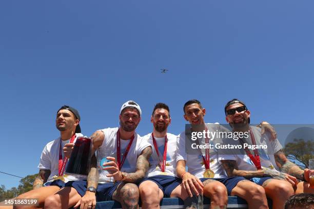 Leandro Paredes, Rodrigo De Paul, Lionel Messi, Ángel Di María and Nicolás Otamendi of Argentina pose for a photo during a victory parade of the...