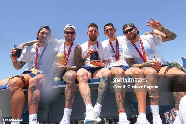 Leandro Paredes, Rodrigo De Paul, Lionel Messi, Ángel Di María and Nicolás Otamendi of Argentina pose with the FIFA World Cup Qatar 2022 Winner's...